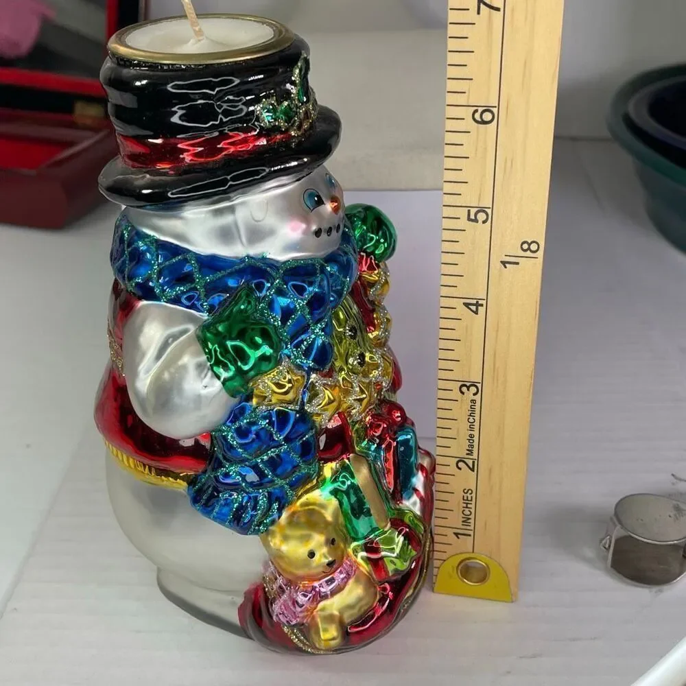 Charming hand-blown mercury glass snowman candle holder.